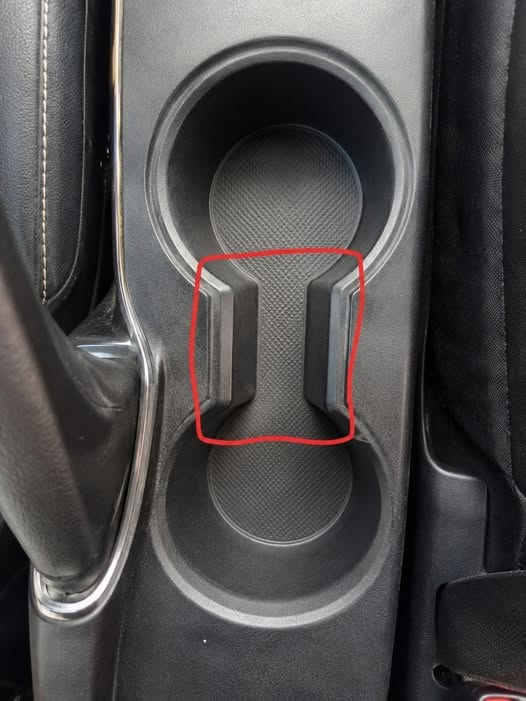 The Small Gap Between Your Car Cup Holders Has a Surprisingly Practical Purpose